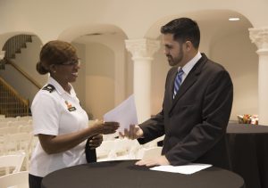 Veteran at podium with Jason Abreu, director of Office of Veteran & Military Services