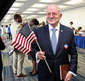 MDC President, Eduardo Padron holds American flag and votes at North Campus