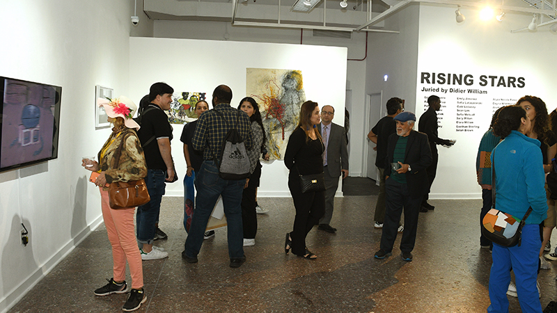 Group of people walking in a gallery