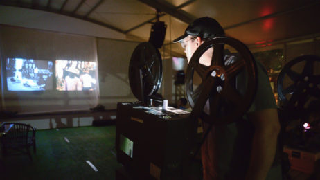 Archive films being projected onto a screen during the 2015 Miami Book Fair