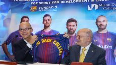 MDC President Eduardo J. Padrón and FC Barcelona First Vice President Jordi Cardoner at a press conference display a sports jersey with the MDC name on it.