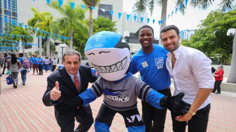 Miami City Commissioner Frank Carollo with Shark mascot, a student and MDC alumnus, singer Jencarlos Canela.