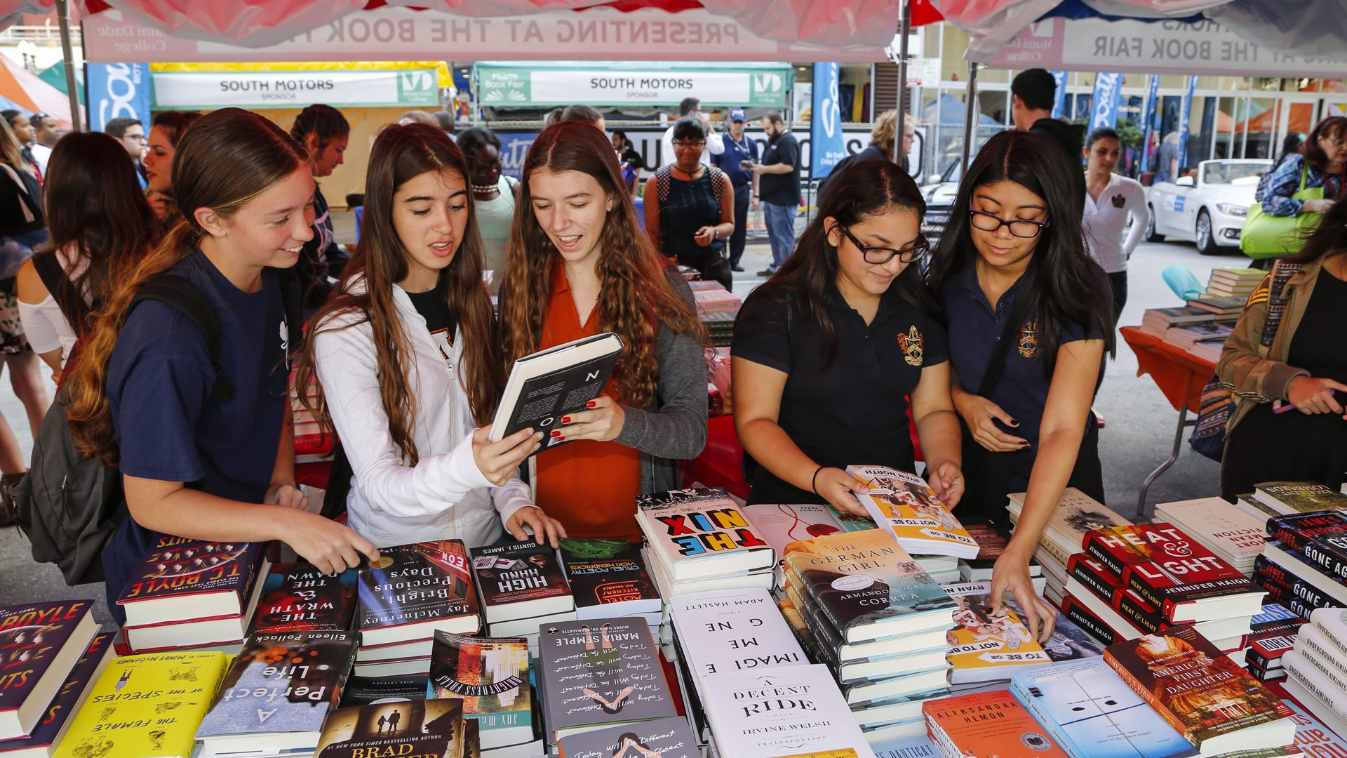 Girls browsing through books at Book Fair