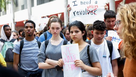 Students hold up protest signs