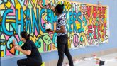 Students work on a wall mural