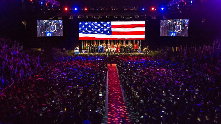 Thousands of students attending commencement in auditorium