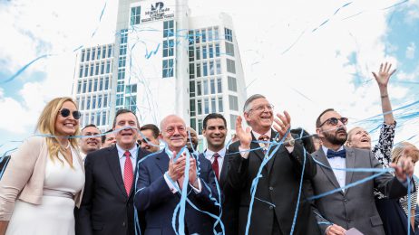 Officials celebrate in front of campus building