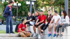 Group of students sitting by stairs outdoor