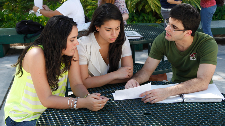 Students sitting together outdoor at campus patio