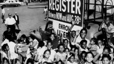 Archival photo registration mobile with black children around it