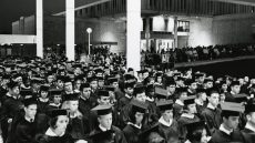 Graduates assembled under two porticos of the Niles Trammell Learning Resources Center building