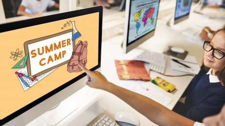 kid's hand pointing at computer screen saying Summer Camp