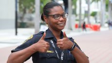 MDC security staff Lucia Cedano smiles and gives two thumbs up