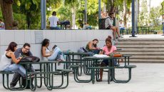 Students at tables on campus