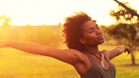 Student photograph of woman with arms outstretched