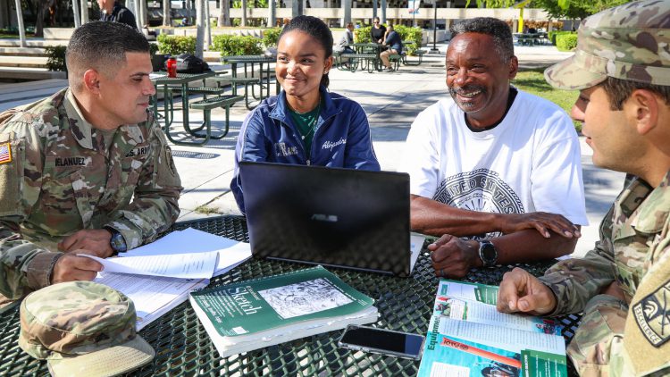 Veterans and students studying outdoors in round-table