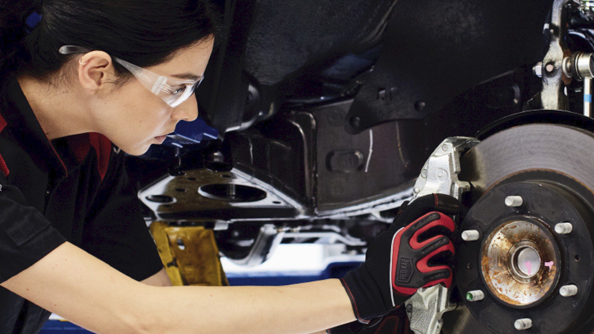 Young woman working on auto repair