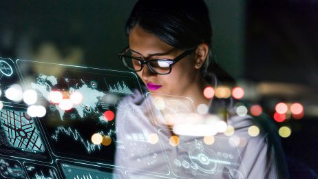 female student sitting in front of computer lights