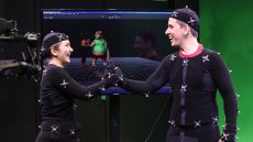Male and female student in front of green screen with motion capture technology