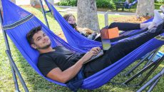 A male and a female student on hammocks
