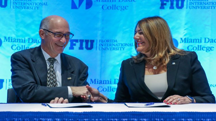 FIU and MDC Presidents shaking hands at signing table