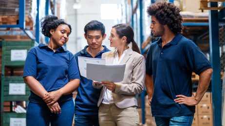 students with supervisor in factory setting