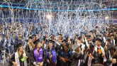 graduates celebrating with streamers falling from the ceiling