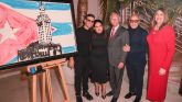 Artist Fabio Ingrassia, Gloria Estefan, Miguel Bezos, Emilio Estefan and President Madeline Pumariega standing next to painting.