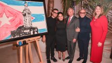 Artist Fabio Ingrassia, Gloria Estefan, Miguel Bezos, Emilio Estefan and President Madeline Pumariega standing next to painting.