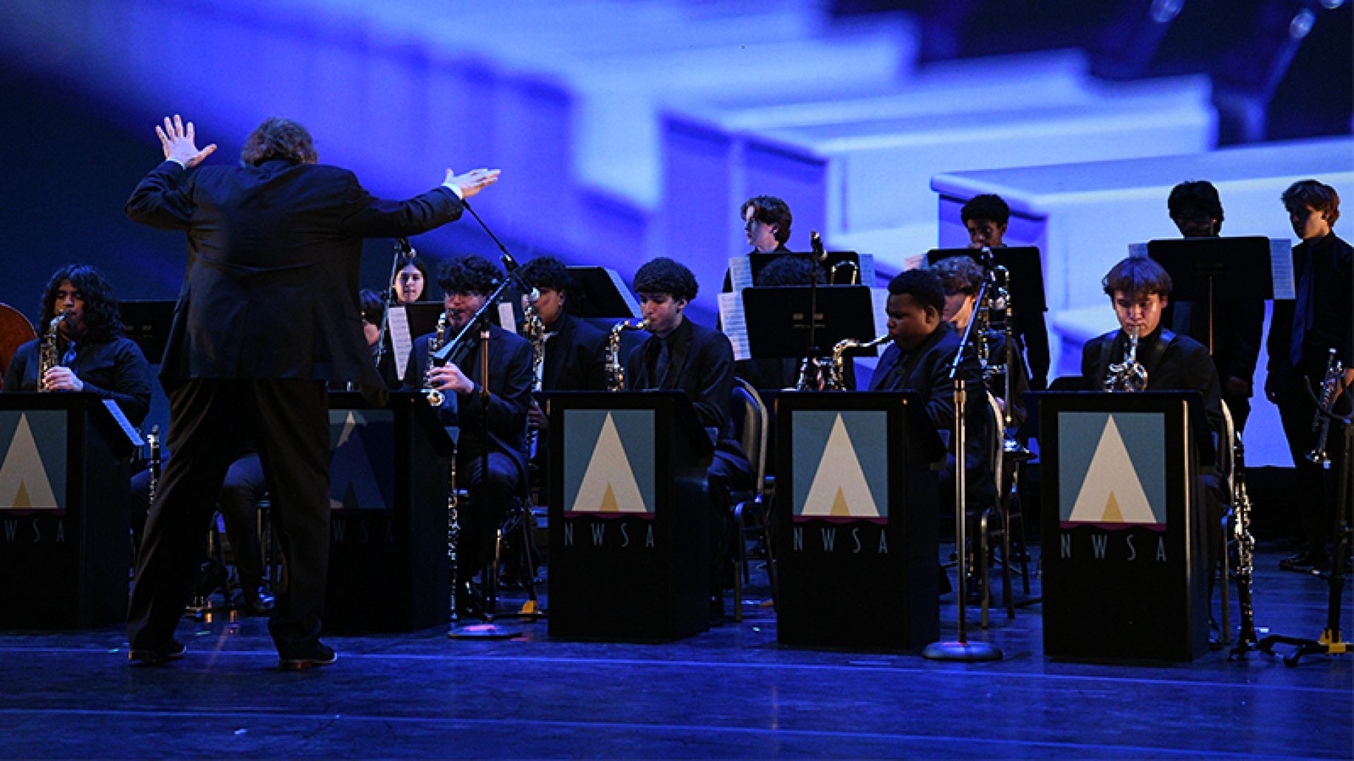 NWSA Jazz Ensemble performing on stage lead by music director