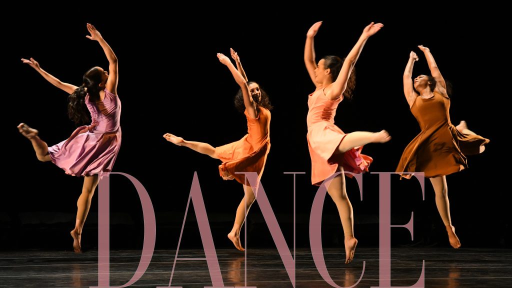 Four dancers leaping on stage.