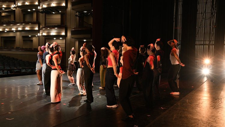 Group of student actors rehearsing on stage.