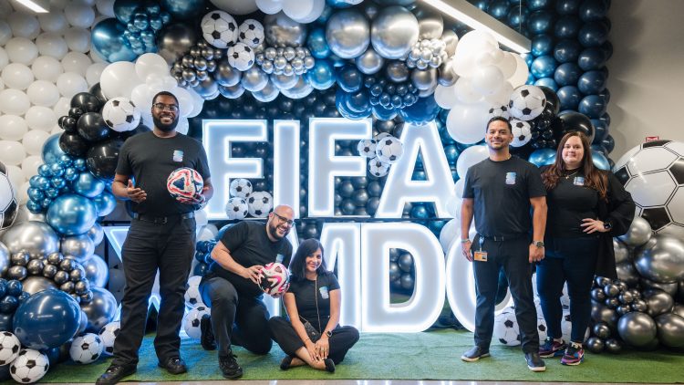 people standing in front of a FIFA/MDC sign