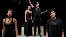 Four people on stage dressed in black.