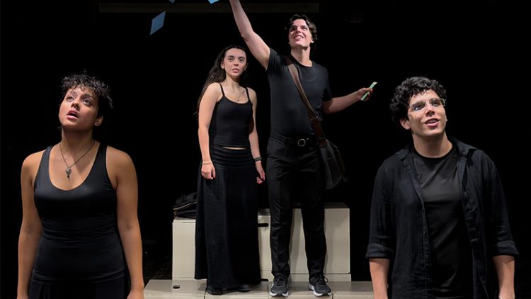 Four people on stage dressed in black.